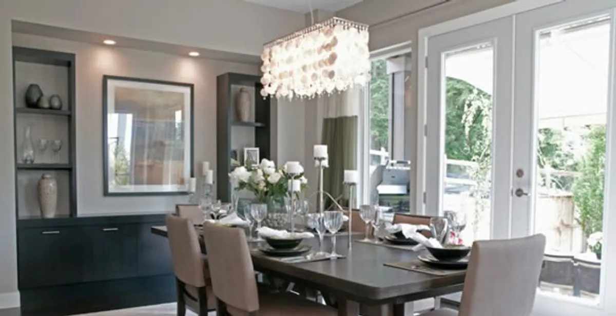 Elegant dining room chandelier installation above table in Los Angeles, CA