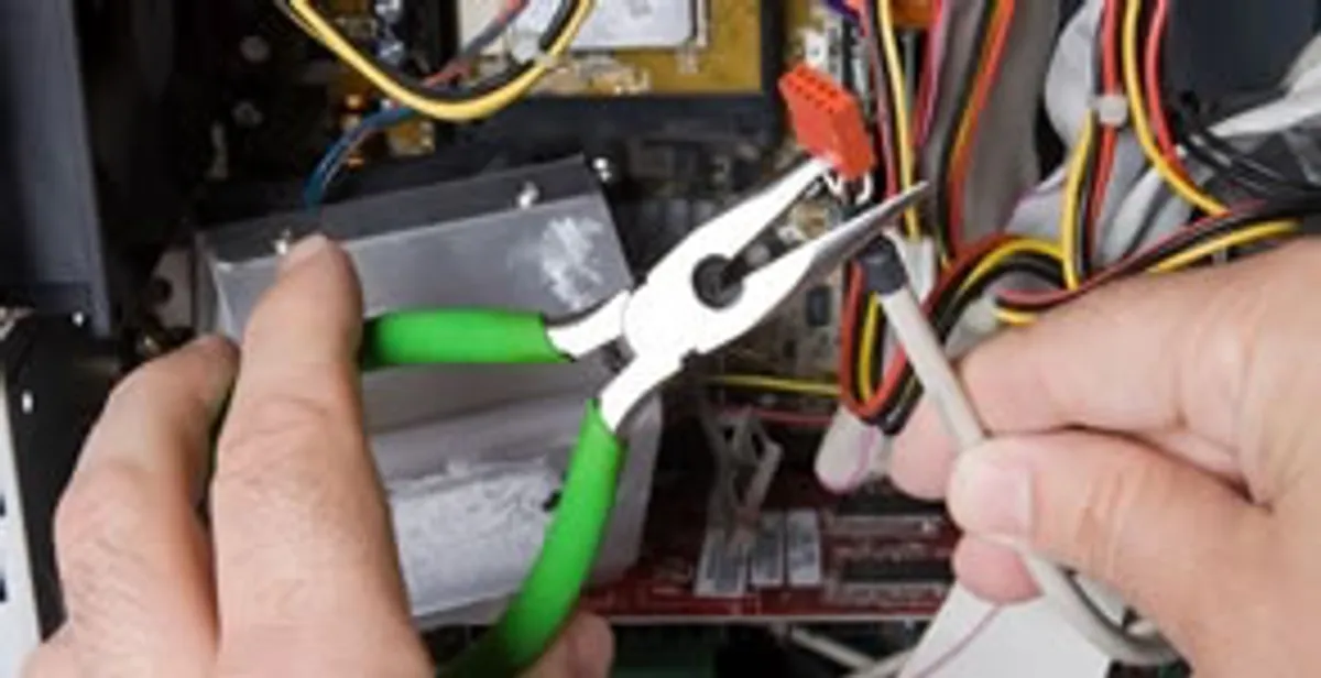 Licensed electrical contractor performing electrical repair with tools in Downey, CA