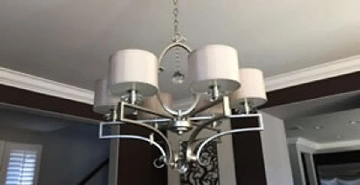 Modern chandelier installation with multiple light fixtures in Los Angeles, CA